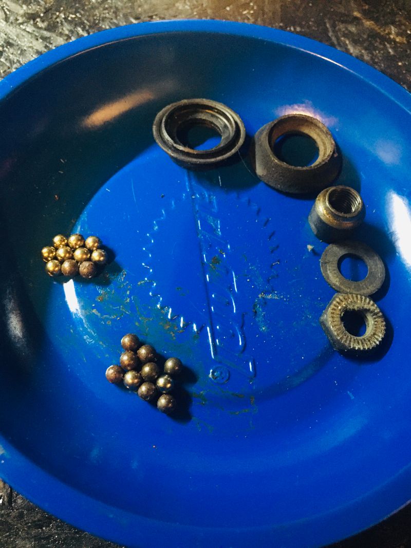 Wheel hub bearings, cones and locknuts in a magnetic tray during servicing